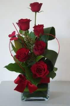 Half a Dozen but Twice the Love - Let her know that she is unique like this custom-designed Arrangements by the artist just for her! This is sure to get recognition and  its an eye-catcher... It includes 6 fresh Roses of your color choice with folded aspidistra leaves and wispy filler and a heart accent. 