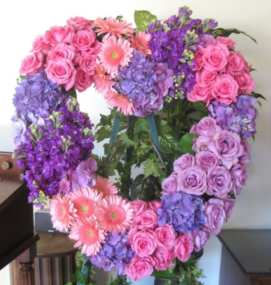 Love Always - Funeral heart shaped design with seasonal flowers.  Please mention the colors you would like in the arrangement.