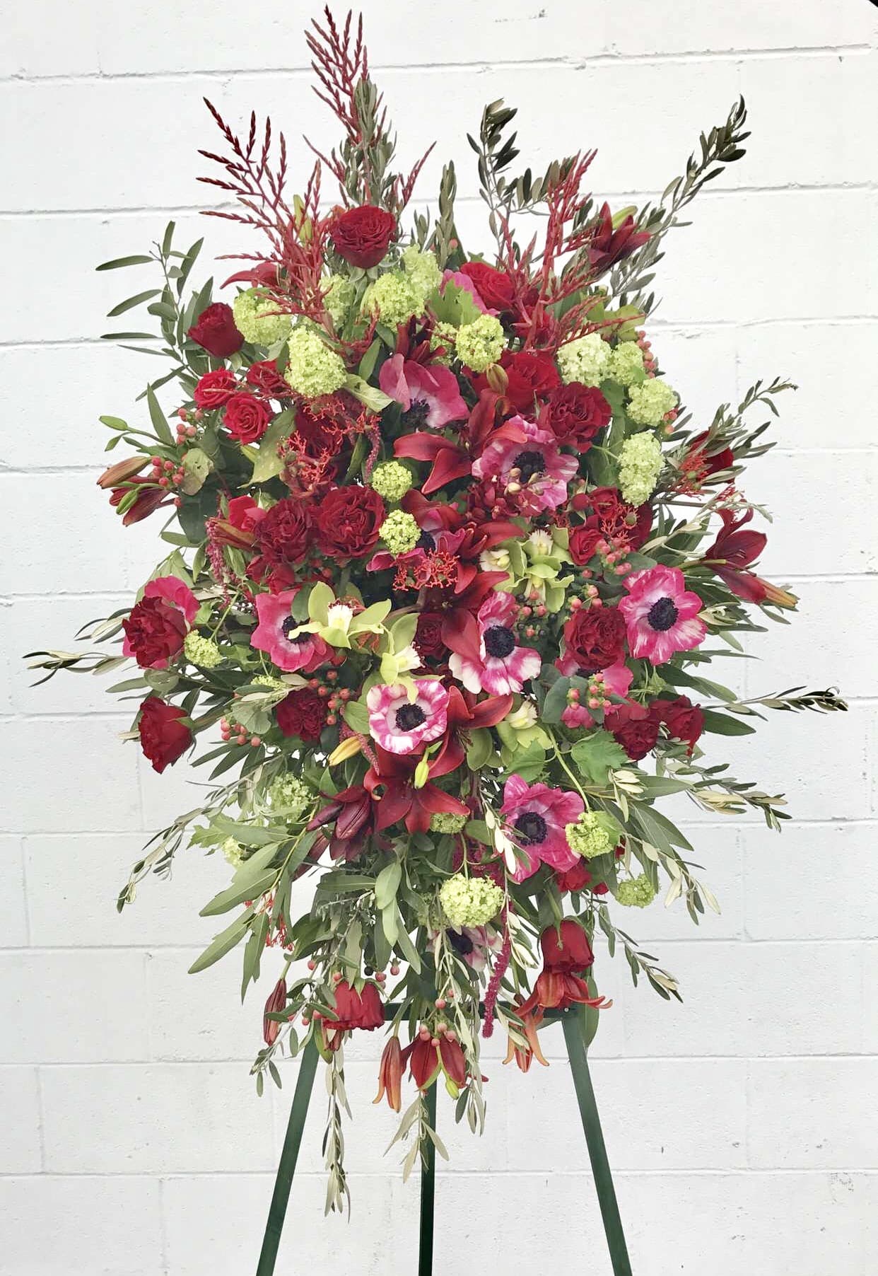 Fire Works - Not everyone you meet is simply amazing.  This particular person made an impact on your life in a way that you will never forget.  Just because someone transitions doesn't mean you must forget them.  Have us design for you a colorful stand for their service.  Let us know the colors you desire.  Tell us the time and location for your delivery.  It's an honor to be designing for you... what's in your heart and memory, and your story of your connection with this beautiful soul. 