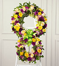 The soul's passage - The soul's passage is reflected by the symbol of &quot;infinity&quot;. The two conjoined wreaths are constructed of yellow roses, fuchsia and purple carnations, fuchsia dianthus, lavender pompons and golden solidago accented with lush greens and trimmed with coordinating ribbon. It is a powerful and lovely statement of faith that is sure to console and comfort all who share your loss. Approximately 39&quot;H x 22&quot;W. 