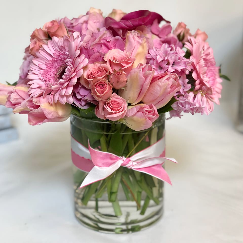 Romantic Pink AD17 - The perfect arrangement for anyone who loves pink, or is the romantic. Our designers will choose the most premium seasonal flowers in tones of pink and artfully arrange them in a clear cylinder vase.  