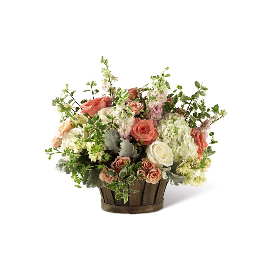 Bountiful Garden -  White and salmon roses made the eyes dance while surrounded by pink larkspur, cream flower, peach spray roses, clouds of white hydrangea, dusty miller stems, and lush greens, arranged to perfection in an oval stained woodchip basket that helps to blend soft sophistication with raw, rustic appeal. That perfect happy birthday, thinking of you, or thank you gift! 