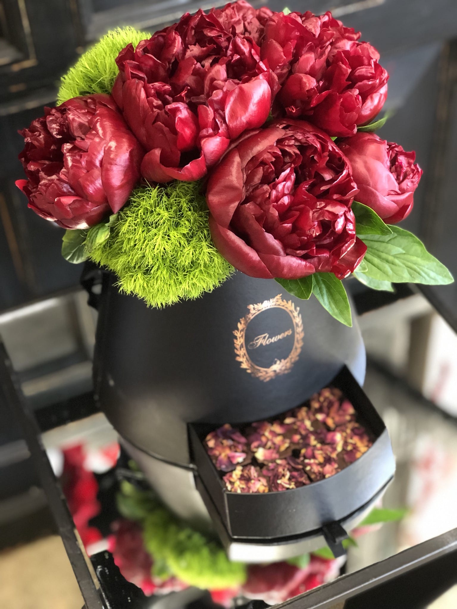  Chic Peonies  - A beautiful display of burgundy peonies and green dianthus in a chic, black box, with a little surprise compartment of rose chocolates. 