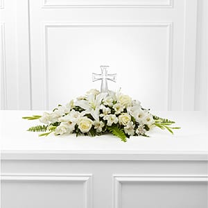  The FTD® Eternal Light™ Bouquet  - The FTD® Eternal Light™ Bouquet is an exquisite arrangement that honors the life of the deceased with each snowy white bloom. A beautiful cross is surrounded by white roses, gladiolus, Peruvian Lilies, Oriental Lilies, vibrant Boston Fern Fronds and lush greens to create a wonderful memorial arrangement for their final farewell service.   SKU#: ELB