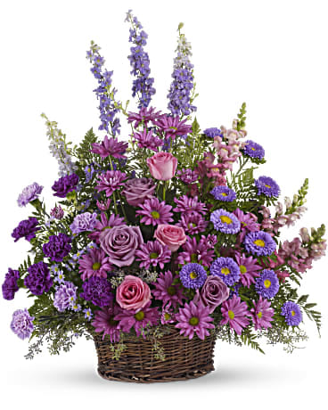 Gracious Lavender Basket - Soothing jewel tones of lavender, purple and pink come together to celebrate a life and comfort friends and loved ones - an abundant basket of fragrant country blooms that pays tribute to someone truly special.