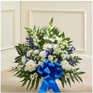 Tribute Blue &amp; White Floor Basket Arrangement -  Blue &amp; White Floor Basket Our elegant floor basket arrangement is a heartfelt way to express your deepest sympathies for their loss. With blue flowers to symbolize tranquility and white flowers to symbolize peace, this beautiful gathering of fresh roses, snapdragons, blue delphinium and more conveys all the care and concern you feel for them during this difficult time •Large arrangement measures approximately 32&quot;H x 42&quot;L •Medium arrangement measures approximately 32&quot;H x 40&quot;L •Small arrangement measures approximately 32&quot;H x 36&quot;L   