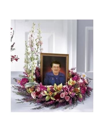 Fare Thee Well Wreath Fare Thee Well Wreath - Spray roses hot pink mini Gerbera daisies pink larkspur and heather are combined in this beautiful wreath. This design of pink blooms is intended to embrace a photo of your loved one during a memorial service. Approx. 25 x 17.5 FCS34-3799