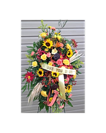Always Remembered Spray Always Remembered Spray - This hand arranged standing spray includes Sunflowers yellow Roses pink Carnations orange Lillies red Gerber Daisies yellow Fugi Mums and Hypericum Berries. All flowers and colors are subject to change due to availability. FCF-0309