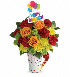 Teleflora's Fun 'n Festive Bouquet Teleflora's Fun 'n Festive Bouquet - Light orange roses, red carnations, green button spray chrysanthemums and yellow cushion spray chrysanthemums are arranged with fresh lemon leaf. Delivered in a Cheers to You mug. Approximately 12 1/2 W x 13 1/2 H