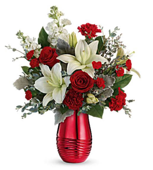 Radiantly Rouge by TF - Make Valentine's Day shine with this romantic mix of classic red roses and crisp white lilies, arranged in a radiant ceramic keepsake vase with mirrored crimson finish! Red roses, white asiatic lilies, red carnations, red miniature carnations, and white stock are arranged with dusty miller, parvifolia eucalyptus, and lemon leaf. Delivered in Teleflora's Radiantly Rouge Vase. Orientation: All-Around - available in Standard, Deluxe &amp; Premium