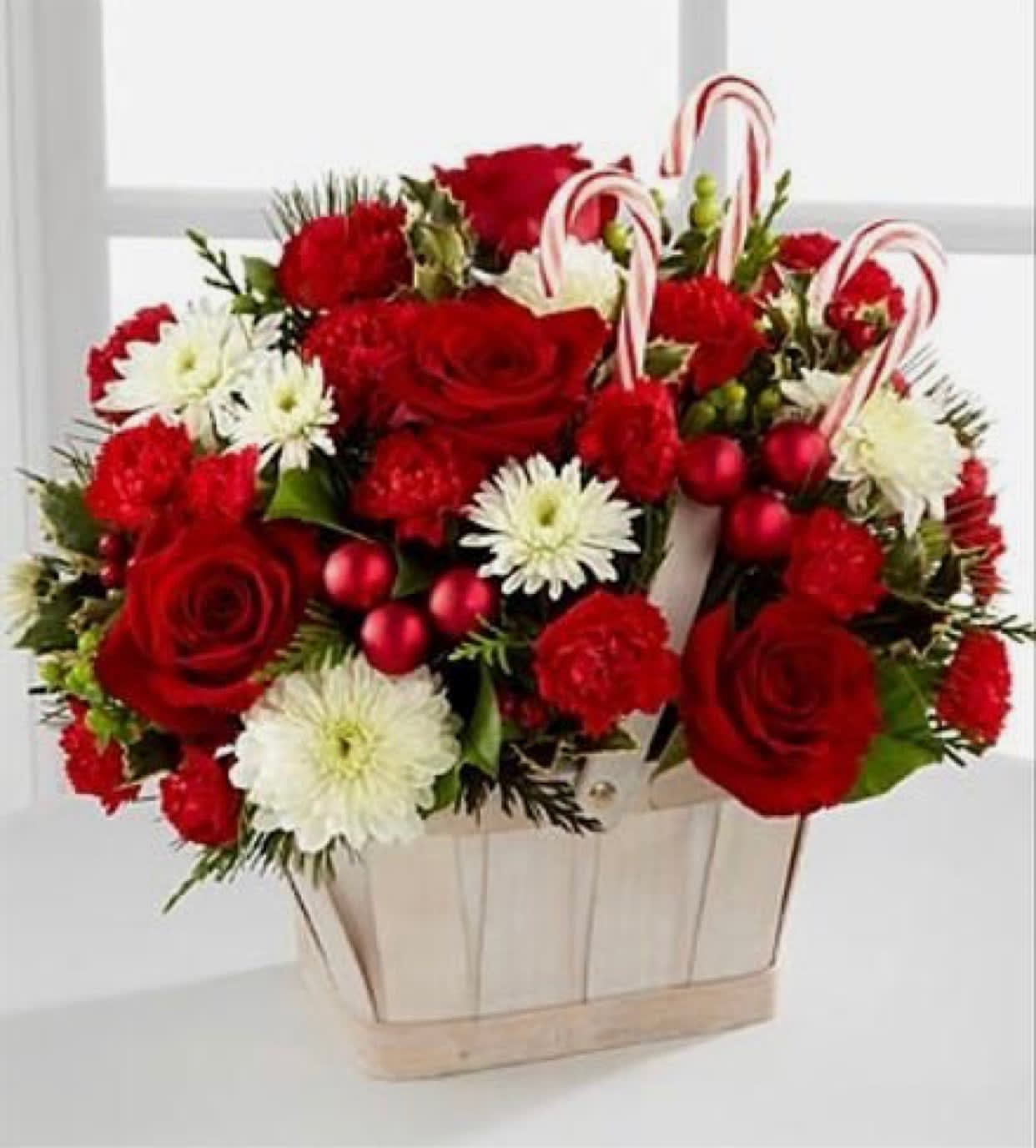 Candy Cane Christmas Basket Candy Cane Christmas Basket - Our candy cane christmas basket includes; white mums; red roses; red carnations; green hypericum berries; accented with our assorted christmas greenery!! Also includes candy cane sticks and red bulbs!!