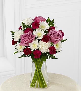 The FTD® My Sweet Love™ Bouquet - B18B-4947  The FTD® My Sweet Love™ Bouquet sends fresh color and light to their door. Stunning lavender roses and purple mini carnations make the ultimate statement surrounded by white carnations and chrysanthemums all beautifully accented with lush greens to create an exquisite flower arrangement. Presented in a modern clear glass vase, this flower bouquet blooms with your most heartfelt wishes.