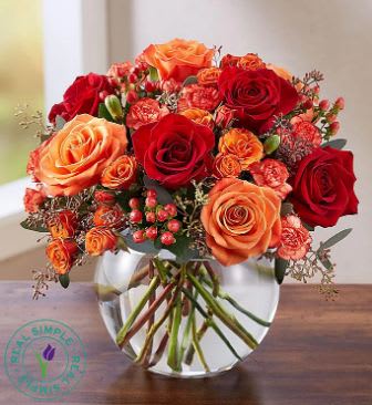 Autumn Medley Autumn Medley - Modern, yet classic all-around arrangement with red roses and hypericum, orange roses, spray roses and mini carnations; accented with exotic, lush greenery and artistically designed in a clear, reusable glass bubble bowl perfect for autumn, Thanksgiving, or any fall function! Available for same day delivery by Denver's fresh flower florist, Floral Expressions!