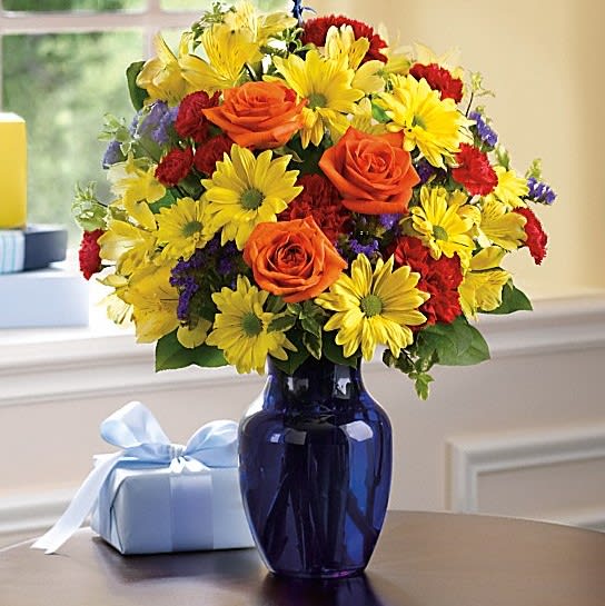 Fly Away Birthday Bouquet - Up, up and away! Take that special someone's birthday to new heights with this happy arrangement and mylar balloon. Bold primary colors and a deep blue vase make it a great pick for sending birthday cheer to men.