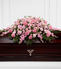 The FTD® Sweetly Rest™ Casket Spray The FTD® Sweetly Rest™ Casket Spray - The FTD® Sweetly Rest™ Casket Spray is a wonderful way to commemorate a life abundant in beauty and love. Blushing pink roses, spray roses, carnations, gladiolus, mini carnations and Asiatic lilies are elegantly arranged amongst an assortment of lush greens to create a sophisticated display meant to bedeck the top of thier casket at the final memorial service.