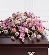 The FTD® Immorata™ Casket Spray The FTD® Immorata™ Casket Spray - The FTD® Immorata™ Casket Spray offers soft beauty and blushing comfort to honor the life of the deceased. Lavender roses, chrysanthemums and parrot tulips are elegantly arranged amongst pink carnations, gladiolus, stock, hydrangea and lush greens to create a presentation, intended to bedeck the top of the casket, that evokes sweet memories of your loved one for their final farewell service.