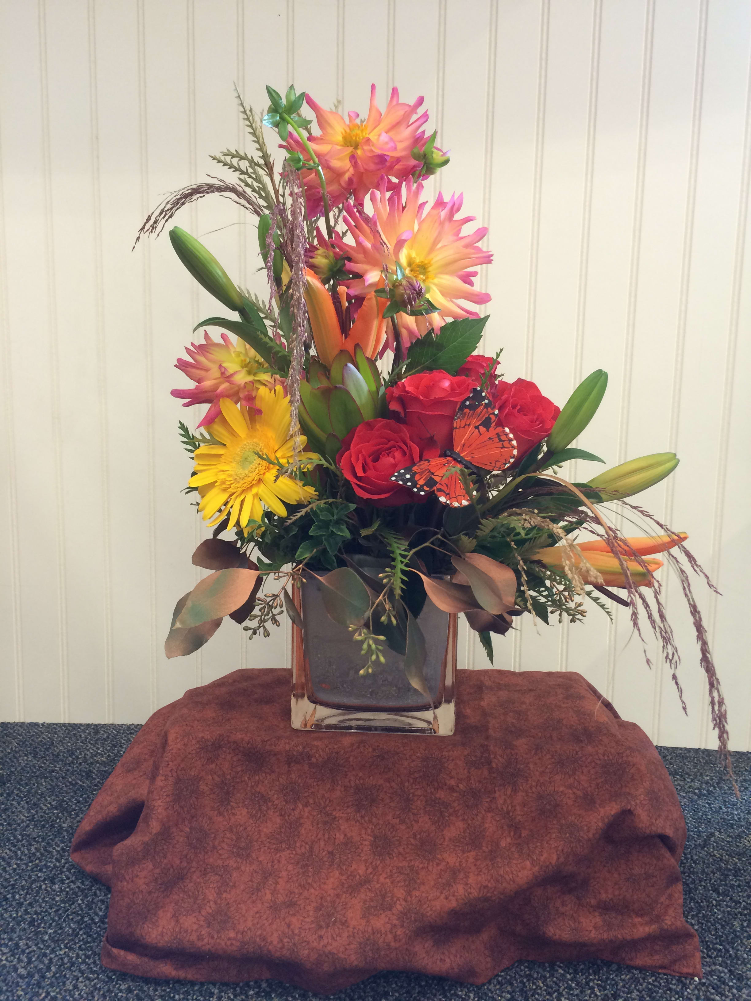 Copper Sensation - A colorful design of dahlias, roses, gerbera daisies, lilies and leucadendron, sure to brighten anyone's day! 