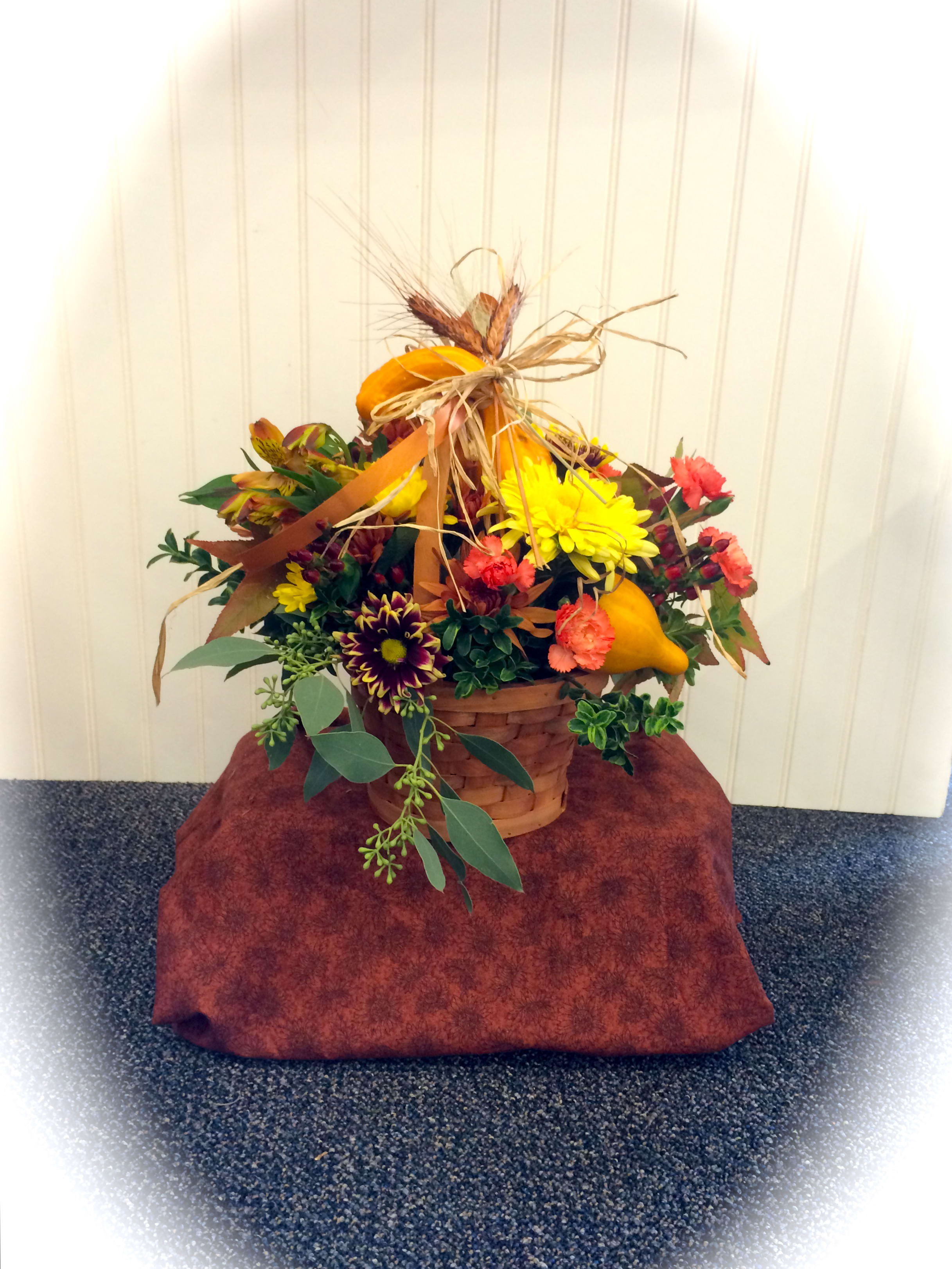 Autumn Basket - A fall basket of mums, mini-carnations, eucalyptus &amp; greens. Tied with raffia, wheat and accented with gourds!