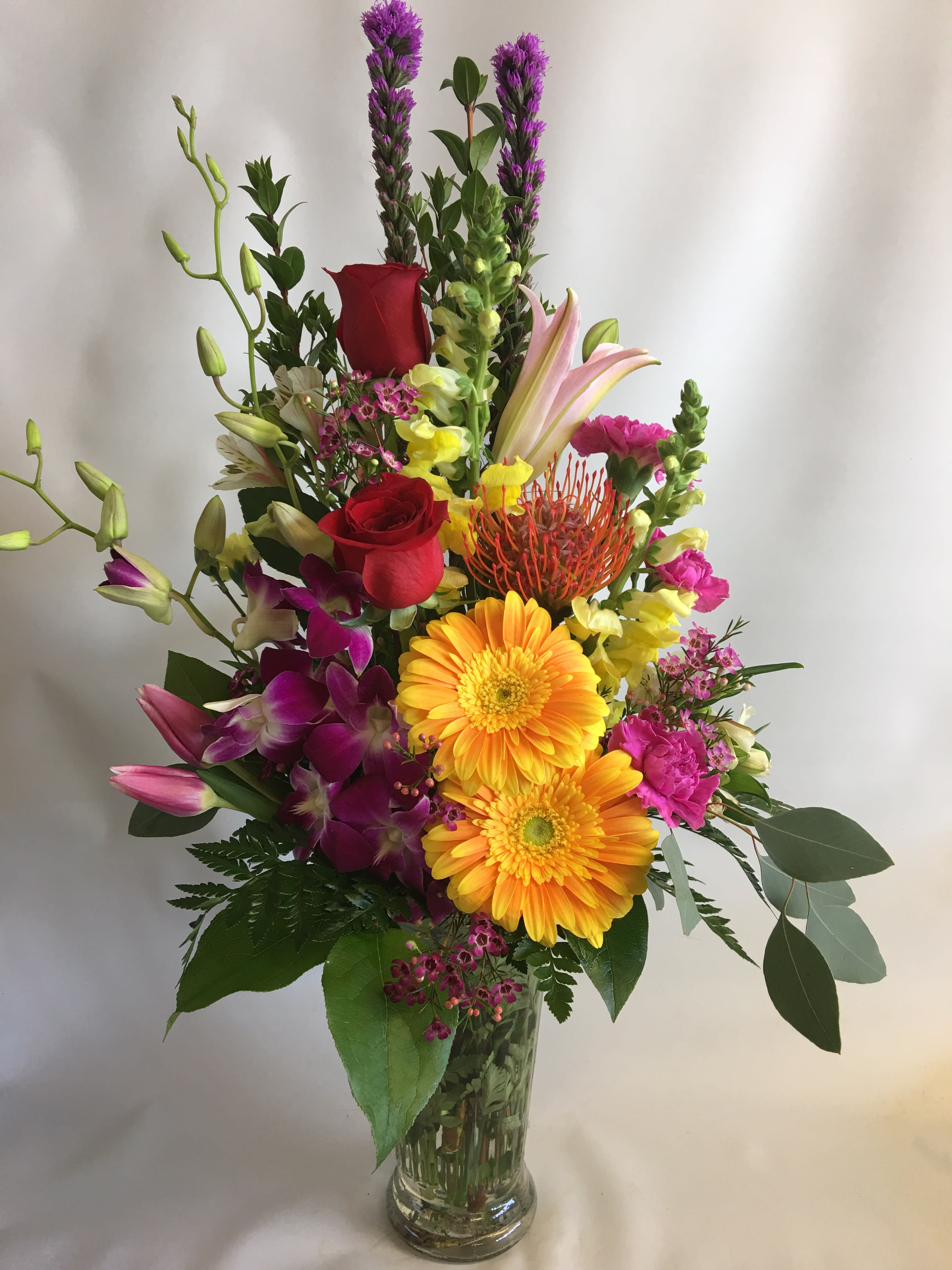 Happiness To Your Heart  - A tall mixed bouquet in a clear vase. 
