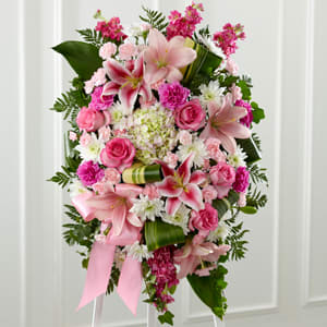 Gently into the Ever-After Standing Spray Gently into the Ever-After Standing Spray - Beautiful colors and textures fill this spray with liles, roses, pom poms, hydrangea & tropical green. Script can be added to the ribbon.