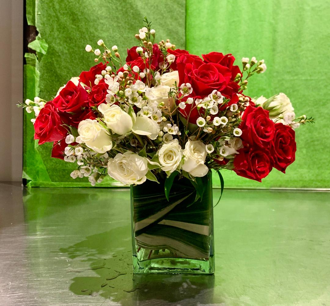 Red & White Delight Red & White Delight - Custom arrangement of red roses, red spray spray roses, white spray roses & wax flowers in clear glass cube.