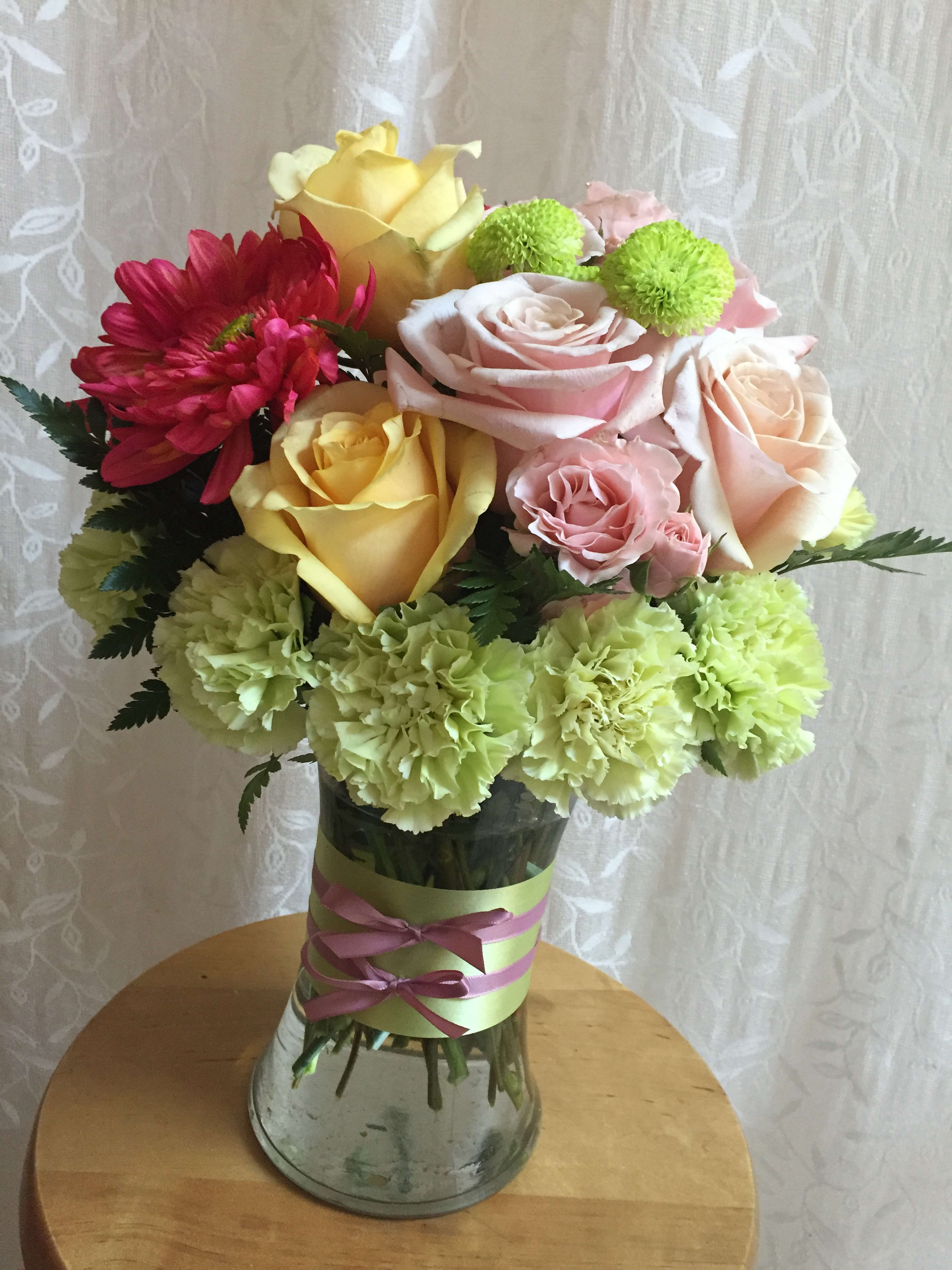 Take a Bow Take a Bow - Light pink, yellow, and green bouquet with delicate double bow accent.