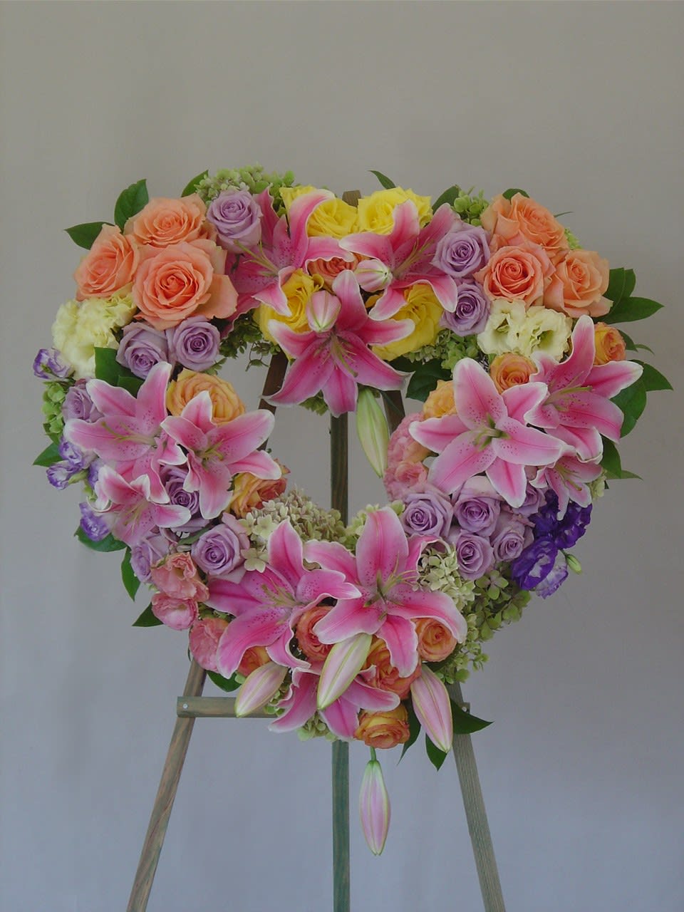 BereavementHeart - Pastel colors, mix of roses, lilies, hydrangeas, lisianthus.  Please see more designs below and call us for a price quote. 