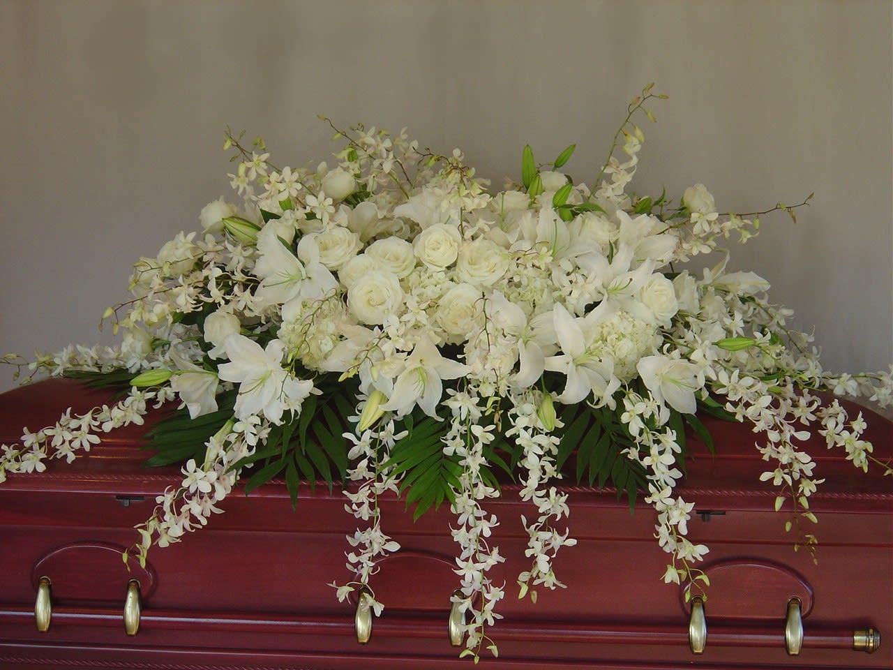 Eternal Rest Casket Eternal Rest Casket - Mix of white flowers like roses, lilies, hydrangeas and dendrobium orchids. Full casket size.