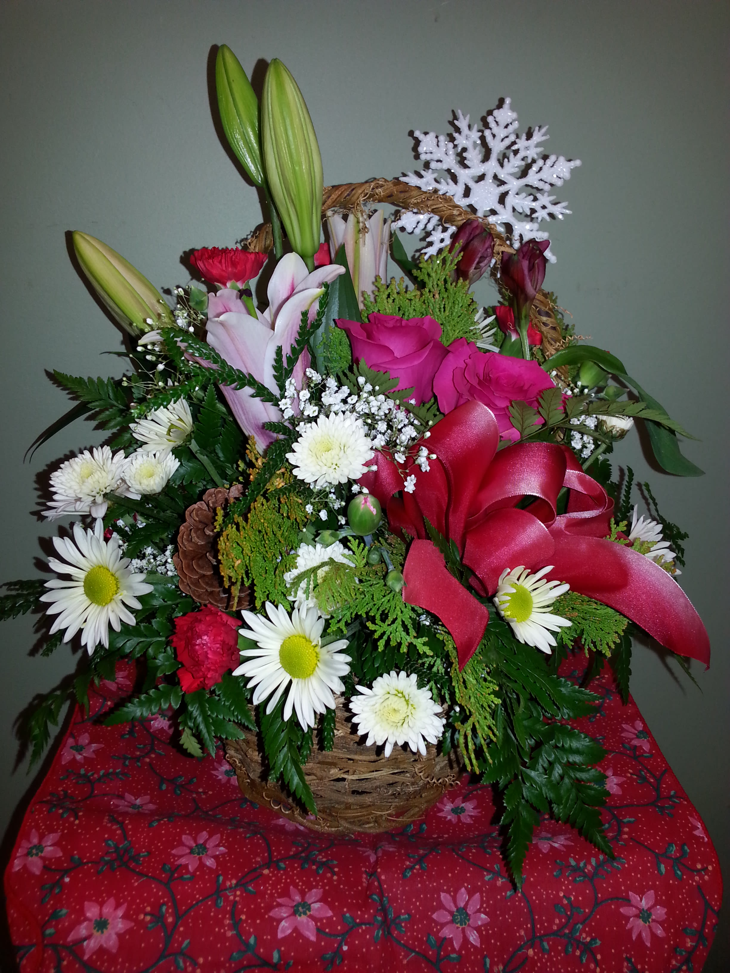Snowflake Garden Basket - Garden mix in shades of pink, white and red artfully arranged all around in a willow basket, with a snowflake ornament attached.