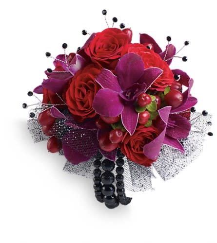 Celebrity Style Corsage - Flirt with fame in this feminine arrangement of exotic orchids roses and hypericum. Purple dendrobium orchids red spray roses and red hypericum with black rhinestone accents.Approximately 5 1/2&quot; W x 5 1/2&quot; H Orientation: N/A As Shown : TPR07-2A