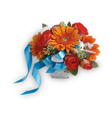 Sunset Magic Corsage - Glorious orange roses and gerberas accented with charming seashells for a magical beachside feel. Dark orange spray roses and miniature orange gerbera with small seashell accents.Approximately 5&quot; W x 4&quot; H Orientation: N/A As Shown : TPR02-2A
