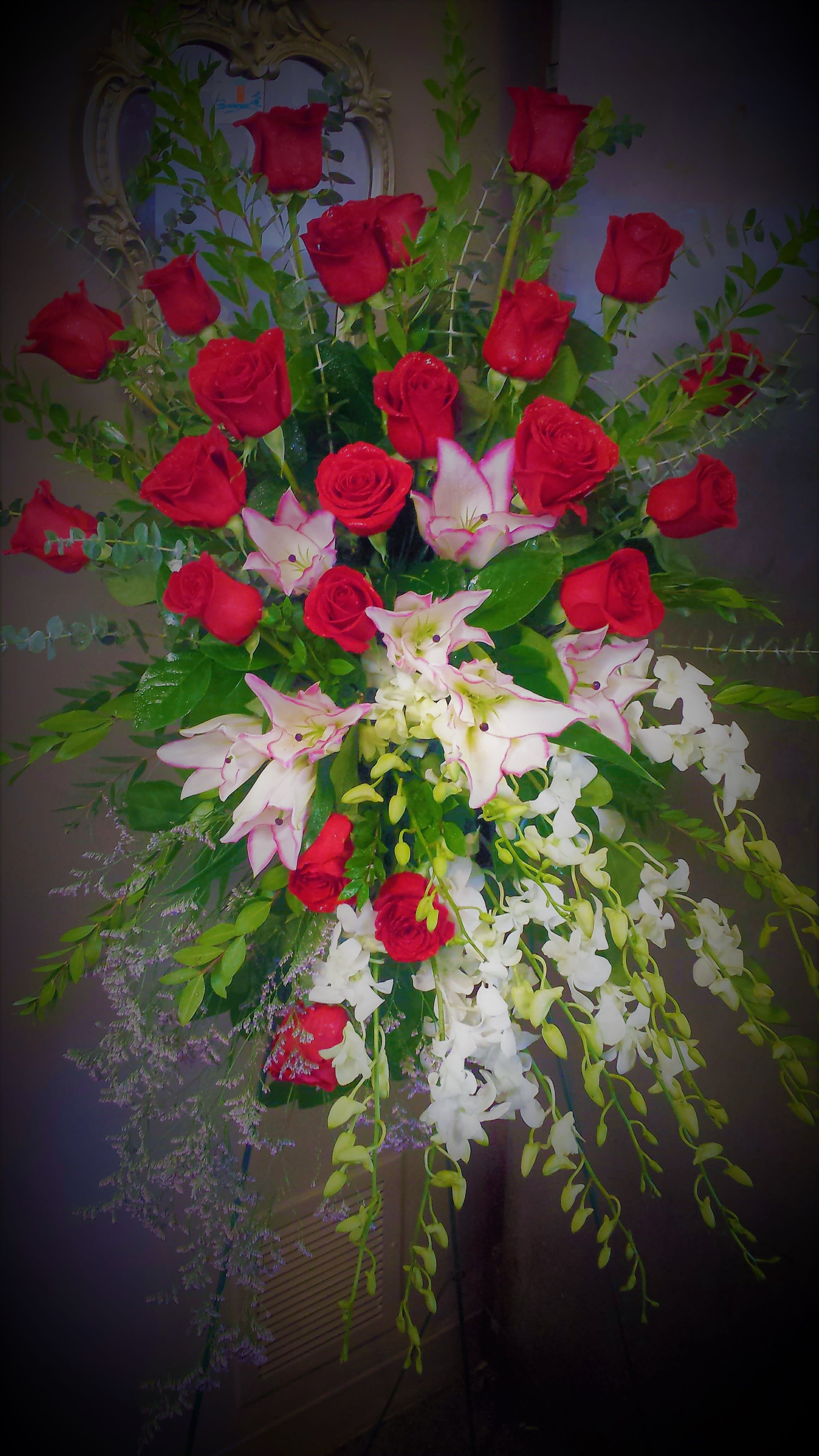 Unity Tribute - easel spray for the service.  Red roses, white lilies, and white orchids  offer  a  grand tribute .