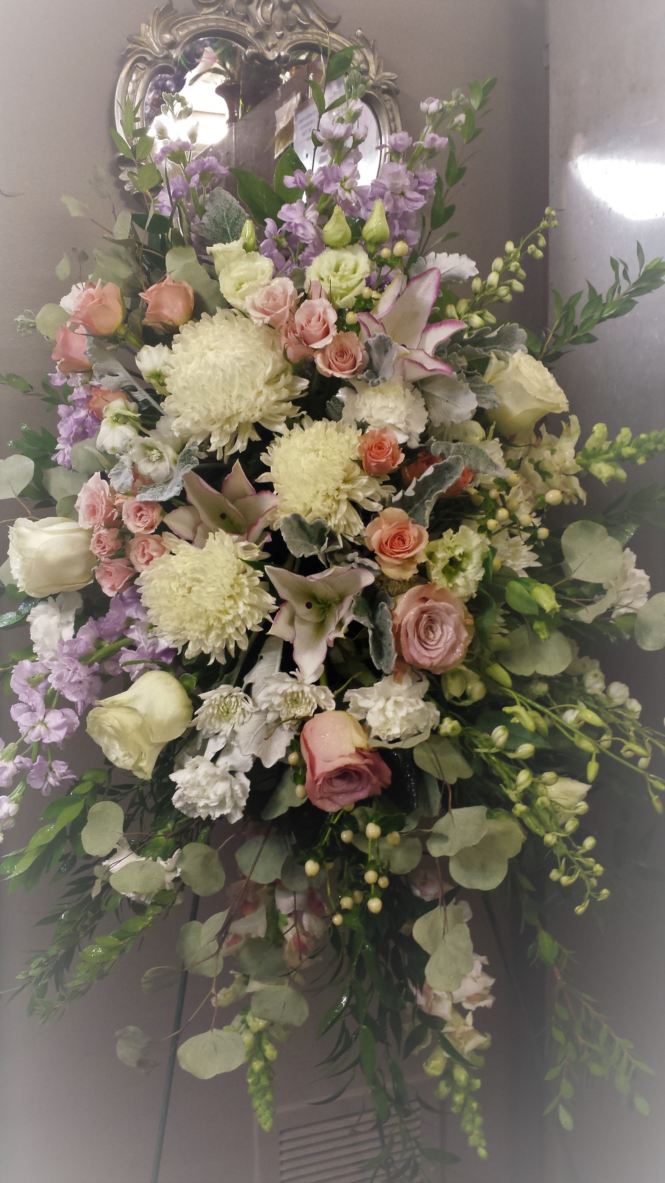 Elegant whisper - A soft, gentle floral tribute in delicate pastel hughes will be a gentle reminder of your caring thoughts