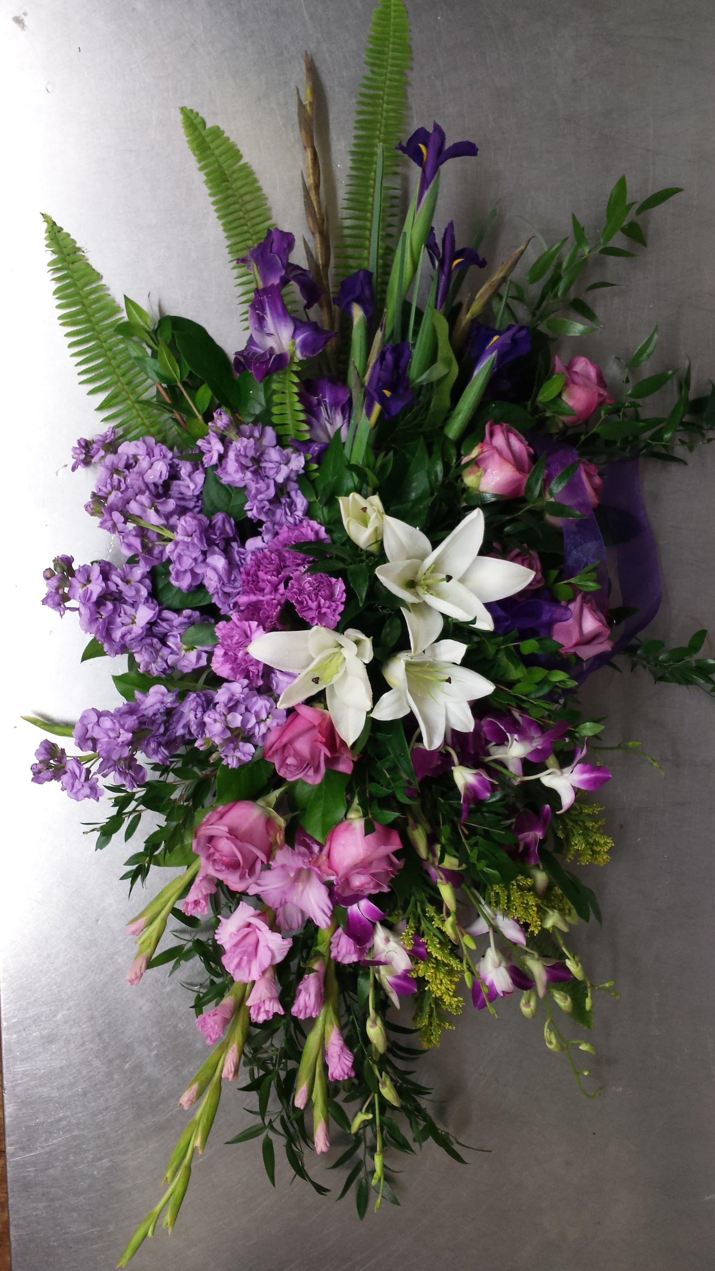 Lavender and white standing spray - A simply striking spray of lavender and white flowers  will be the perfect way to convey your sentiment .  Roses, iris, lily , and orchids 
