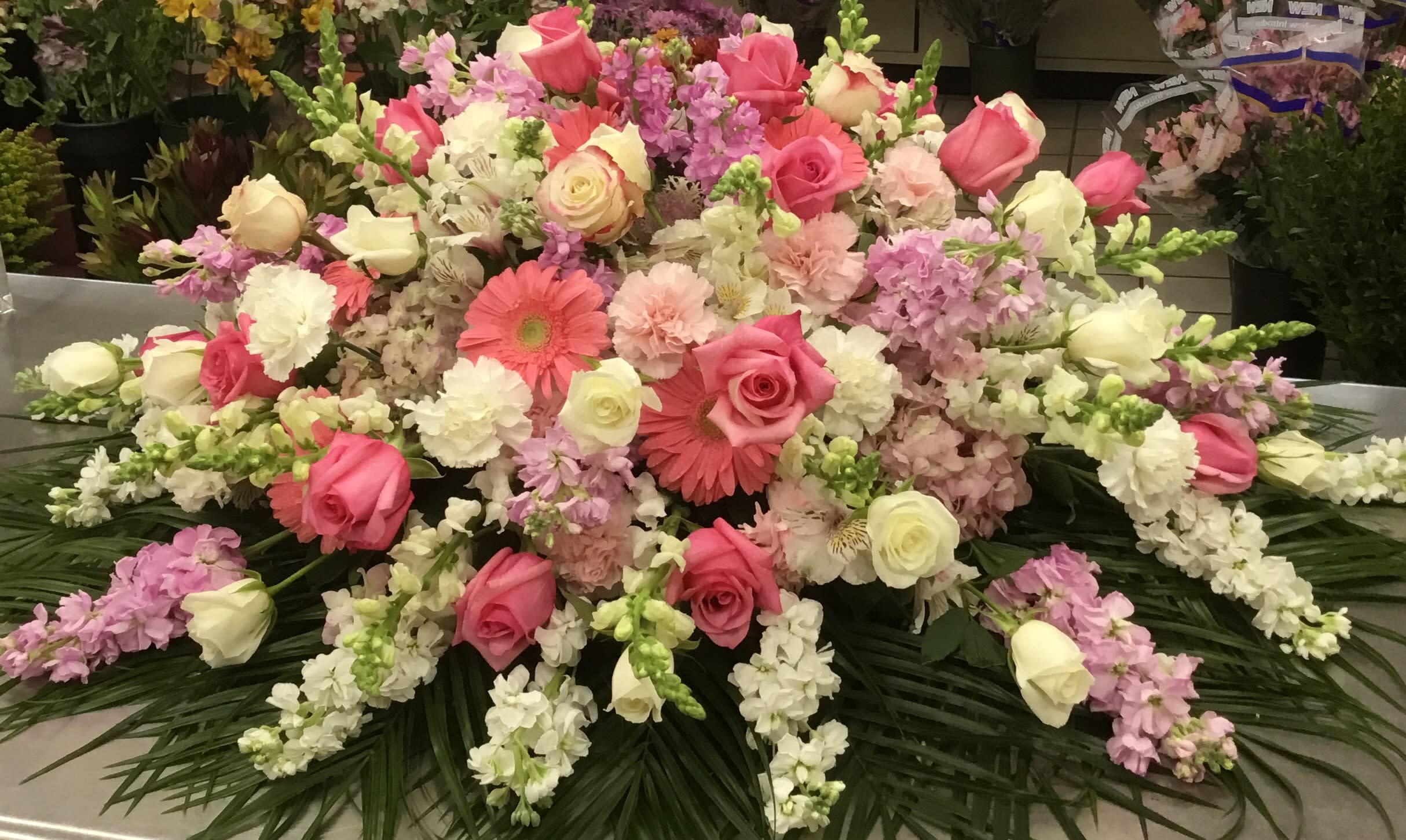 Magnificent pink and white casket piece by Flowers by Ami