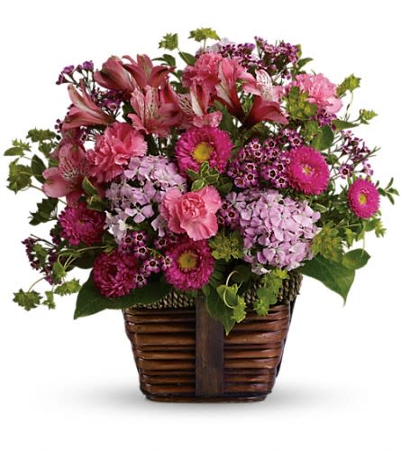 Happily Ever After - Send someone this delightful floral gift of pretty pink blossoms and share the gift of beauty! A glorious selection of fresh flowers is arranged in a rustic basket then hand-delivered. What could be lovelier? A mix of fresh flowers such as pink carnations Matsumoto asters Sweet William and alstroemeria is accented with greenery and delivered in a rustic basket.Approximately 13 1/2&quot; W x 12 1/2&quot; H Orientation: All-Around As Shown : T11Z107ADeluxe : T11Z107BPremium : T11Z107C