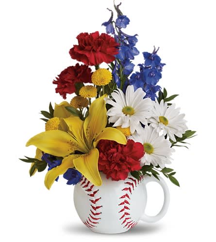 Teleflora's Big Hit Bouquet Teleflora's Big Hit Bouquet - A swing and a hit! You'll really score when you send this charming bouquet to your favorite baseball fan. Bright yellow asiatic lilies blue delphinium red carnations white daisy spray chrysanthemums yellow button spray chrysanthemums and a touch of myrtle are arranged in this oversized baseball mug. It's sure to be a big hit.Approximately 11 1/4" W x 14 1/2" H Orientation: All-Around As Shown : T22-2ADeluxe : T22-2BPremium : T22-2C
