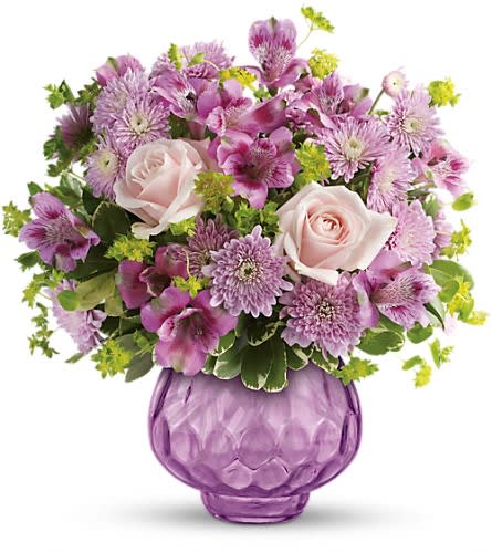 Teleflora's Lavender Chiffon Bouquet - Now here's a real pleaser: a glorious springtime bouquet harmoniously arranged in a sparkling vase. The delicate blooms and soothing lavender palette spread joy to those you love the most. Includes light pink roses lavender alstroemeria and cushion spray chrysanthemums accented with fresh pops of green bupleurum and pittosporum. Delivered in a Brilliant Gem Votive.Approximately 14&quot; W x 14 1/2&quot; H Orientation: One-Sided As Shown : TEV25-2ADeluxe : TEV25-2BPremium : TEV25-2C
