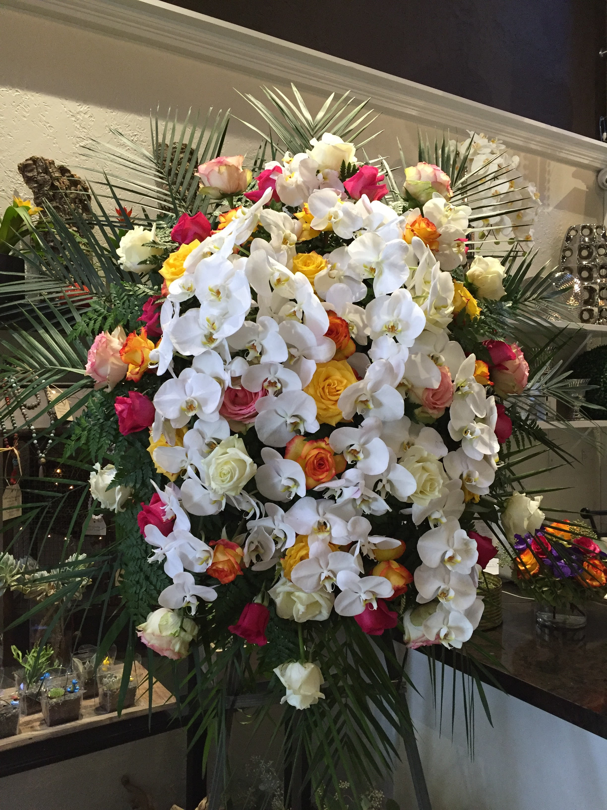Premium Funeral Spray - An amazing combination of flowers creating a magnificent display. Cascades or orchids are blended with various types of roses and other flowers creating a very unique look. 