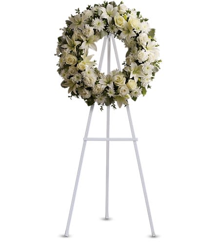Serenity Wreath - A ring of fragrant bright white blossoms will create a serene display at any funeral or wake. This classic wreath is delivered on an easel and is a thoughtful expression of sympathy and admiration. A standing wreath created from fresh white flowers such as roses Asiatic lilies carnations and cushion spray chrysanthemums - accented with greenery - is delivered on an easel.Approximately 22&quot; W x 22&quot; H Orientation: One-Sided As Shown : T239-3A