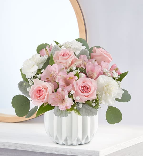 Blushing Pink Bouquet Blushing Pink Bouquet - Sweet-meets-modern for the perfect any-reason surprise. Our new bouquet is filled with blush-colored blooms, hand designed in our modern, white geo vase. Flaunting a sleek satin finish, its faceted ceramic design adds contrast and style, while making someone you care about smile.