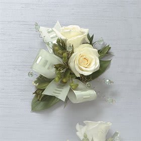 White Rose Pin Corsage - Today's corsages and boutonnieres range from dramatic and sophisticated floral clusters to simply beautiful single stems. The choice is yours!   Approximately 8&quot;H x 8&quot;W x 3&quot;D