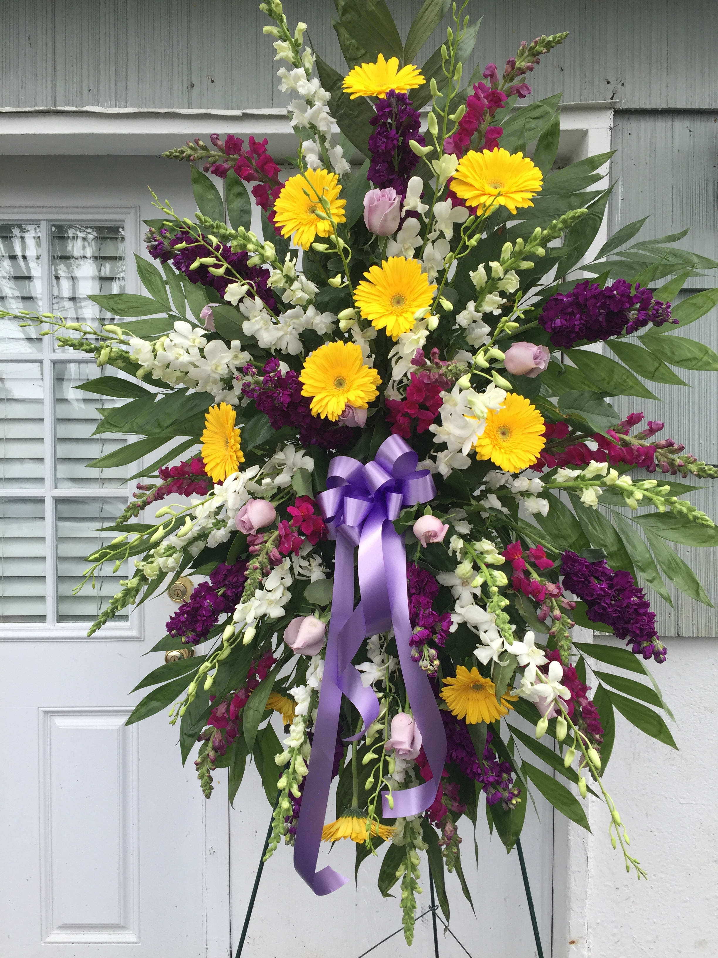 Standing Spray Purple &amp; Yellow - Yellow gerbera daisies, deep purple stock, burgundy snap dragon, white snap dragon, white orchids, lavender roses and premium greens. 
