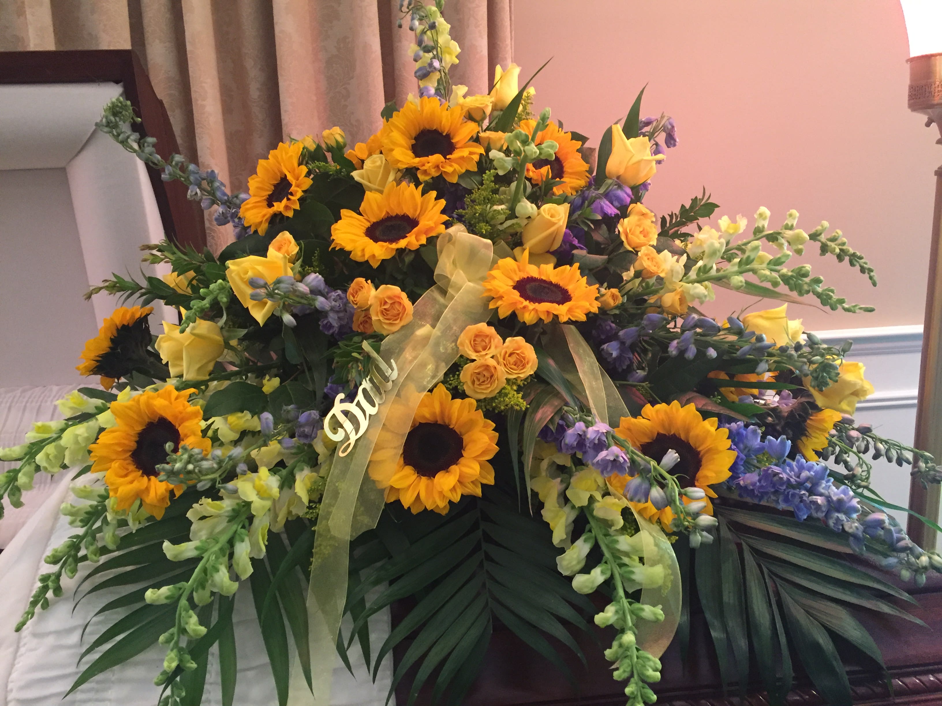 Casket Spray Yellow And Blue By Landmark Florist