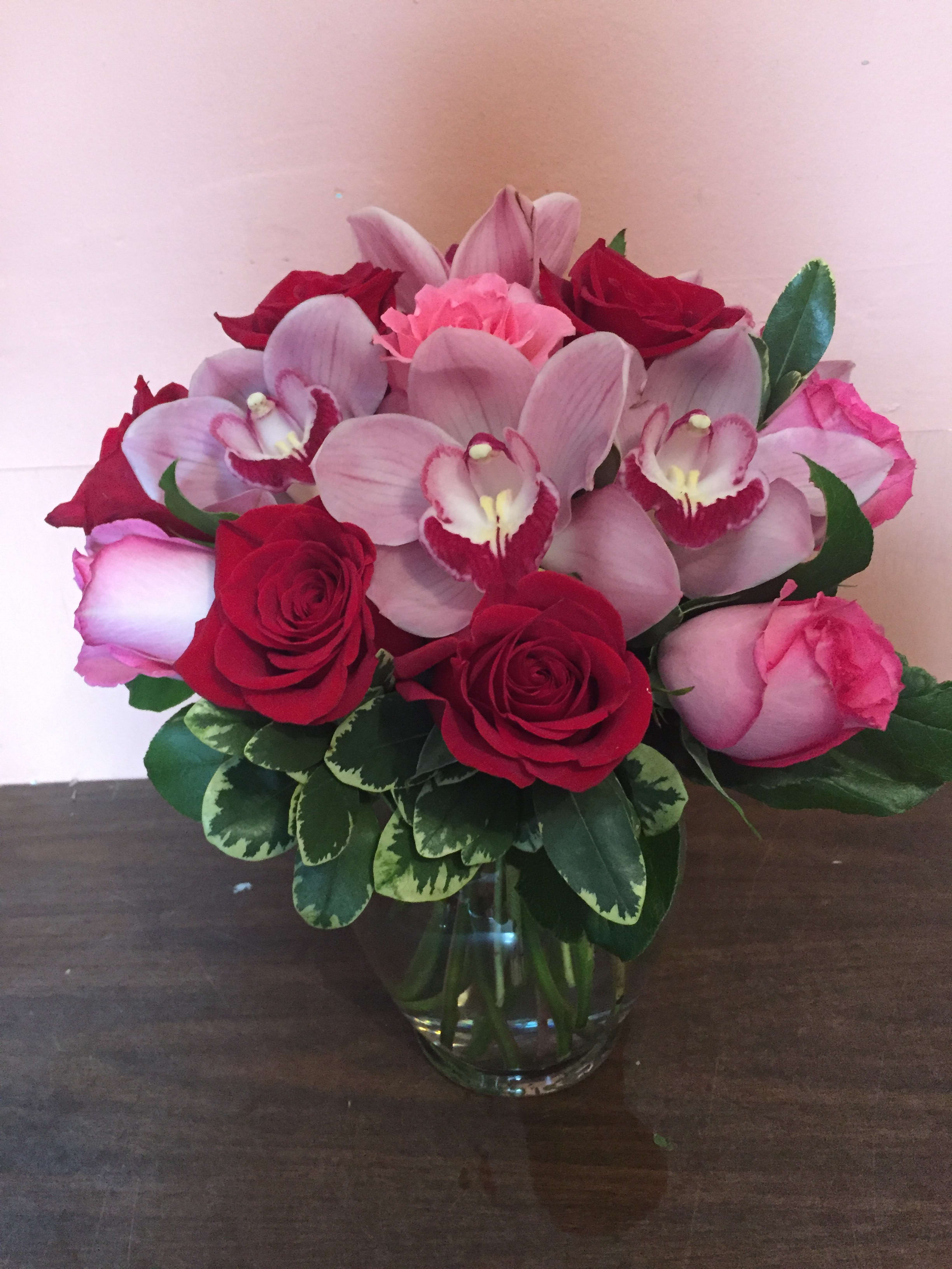 Sending all my love - Vase arrangement with bounty of beautiful premium flowers. Red and pink roses and pink cymbidium orchids. 