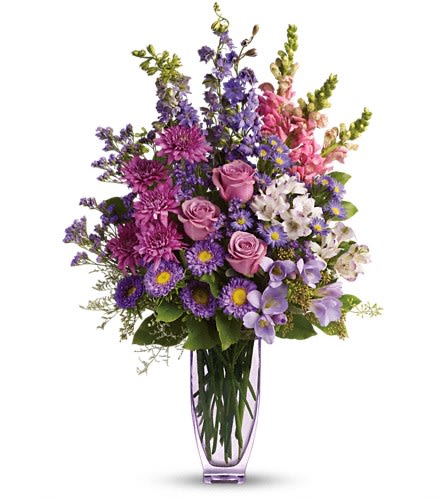Steal The Show by Teleflora with Roses Steal The Show by Teleflora with Roses - You won't have to worry about any other bouquet upstaging this gift! At over two feet tall this is a fabulous way to show someone how much they mean to you. Lovely lavender roses alstroemeria larkspur freesia matsumoto asters and limonium are joined by light pink snapdragons purple monte cassino asters and statice in an exclusive lavender Jewel Vase. The bouquet will definitely steal the show. You might even steal someone's heart.Approximately 18" W x 27" H Orientation: One-Sided As Shown : T49-1ADeluxe : T49-1BPremium : T49-1C