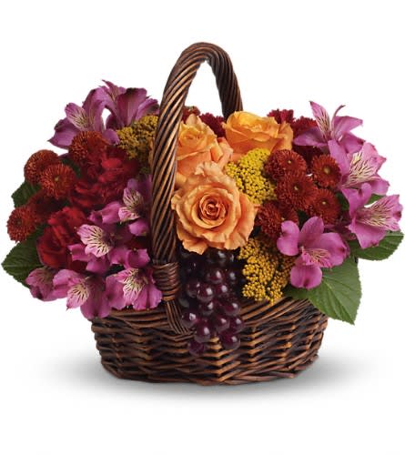 Sending Joy Sending Joy - Know anyone who would really appreciate a basketful of joy right now? Send love and flowers with this beautiful array of fantastic fall flowers. The basket overflows with orange roses and spray roses maroon carnations purple alstroemeria burgundy button spray chrysanthemums yarrow and even a bunch of grapes (not real of course)!Approximately 13 3/4" W x 11 3/4" H Orientation: All-Around As Shown : T173-3ADeluxe : T173-3BPremium : T173-3C