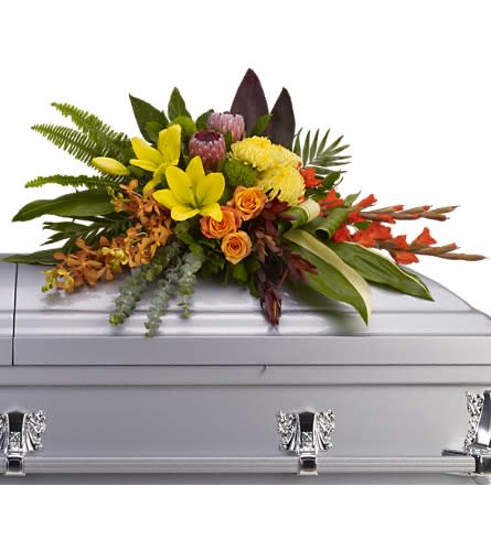 Island Memories Casket Spray - Graceful and fresh this tropical-influenced spray sheds light on memories that will be forever treasured. Splashed with color and grounded with earth tones it lends comfort and hope to any memorial. Yellow asiatic lilies with orange orchids and roses red gladioli pink protea and yellow chrysanthemums are draped across the casket amidst radiating ferns greens and leaves.Approximately 40&quot; W x 22 1/2&quot; H Orientation: N/A As Shown : T244-3A