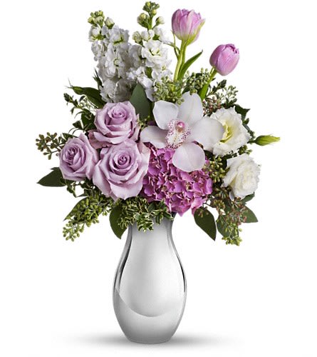 Teleflora's Breathless Bouquet Teleflora's Breathless Bouquet - When we say it will leave her breathless we're not exaggerating. She'll be swept away by the lush lavender roses white orchid and other fabulous favorites in a Silver Reflections vase. The exquisite bouquet includes a white cymbidium orchid lavender hydrangea lavender roses white lisianthus purple tulips and white stock accented with fresh greenery. Delivered in a Silver Reflections vase.Approximately 13 3/4" W x 18 1/2" H Orientation: One-Sided As Shown : T403-2ADeluxe : T403-2BPremium : T403-2C