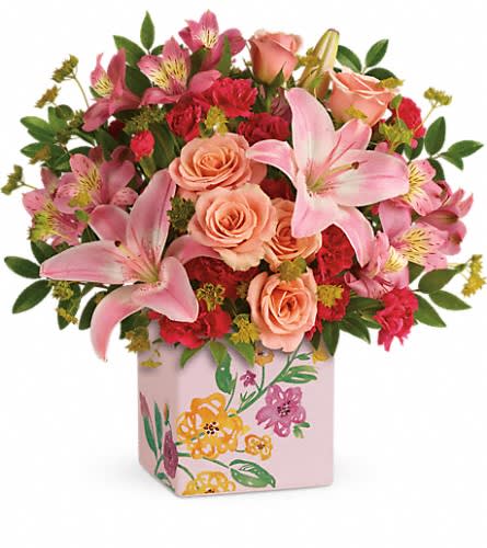 Teleflora's Brushed With Blossoms Bouquet Teleflora's Brushed With Blossoms Bouquet - Glorious pink lilies and radiant peach roses send Mom your most heartfelt wishes for a happy Mother's Day! Presented in a keepsake ceramic cube adorned with painterly blooms it's two gifts in one for twice the fun. Beautiful peach spray roses light pink asiatic lilies pink alstroemeria and pink miniature carnations are arranged with bupleurum and huckleberry. Delivered in a Painted Blossoms cube.Approximately 13 1/2" W x 13 1/2" H Orientation: All-Around As Shown : T16M405ADeluxe : T16M405BPremium : T16M405C
